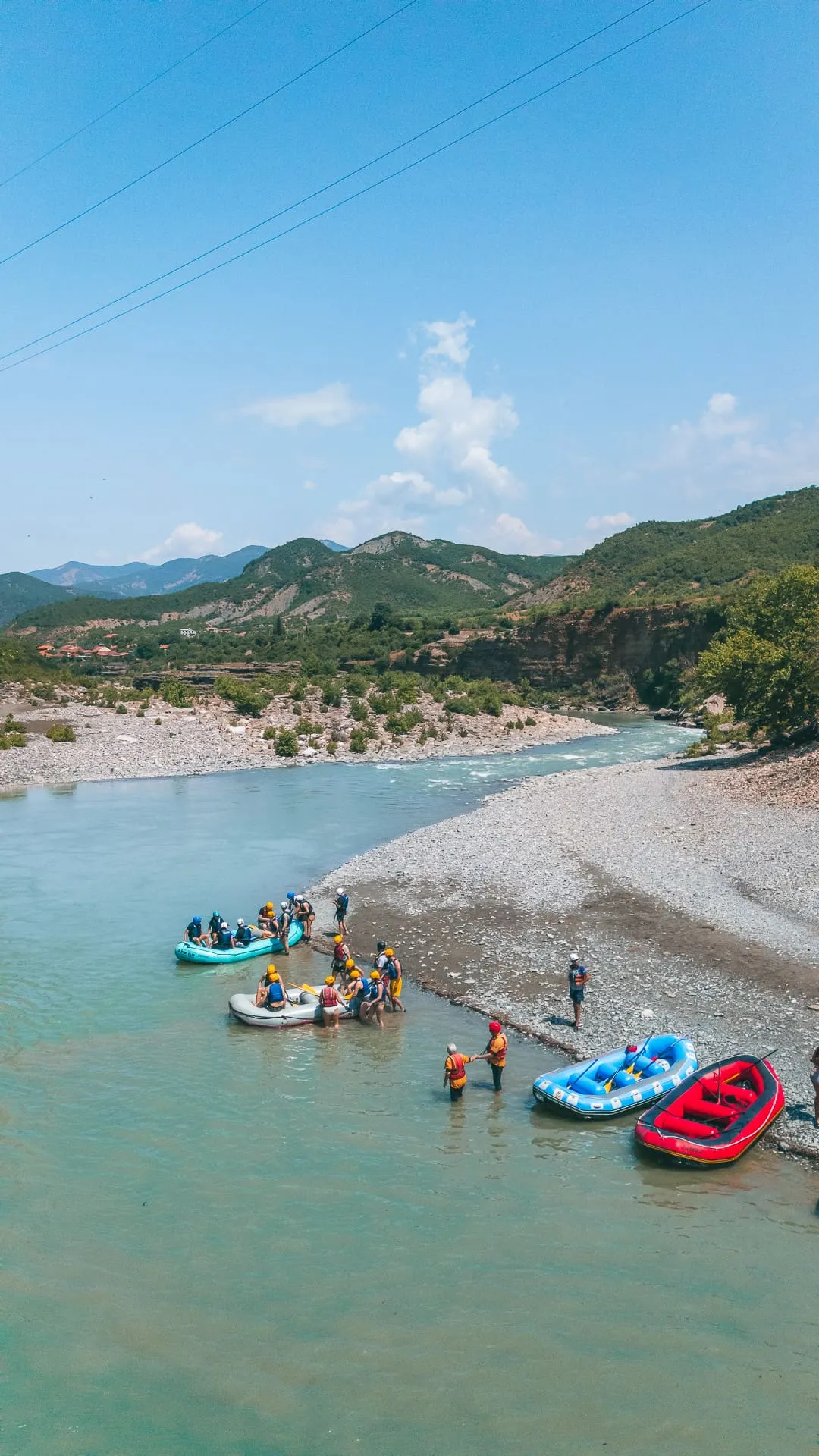 Kayakers on calm blue water in the Vjosa